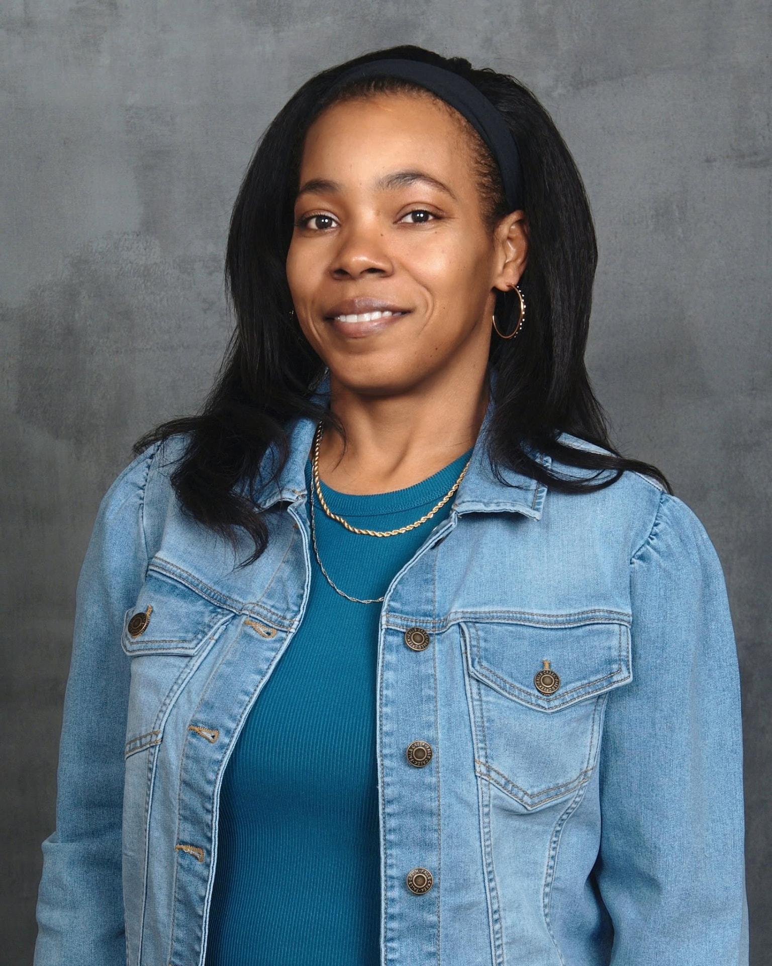 Abike Washington smiling in a denim jacket